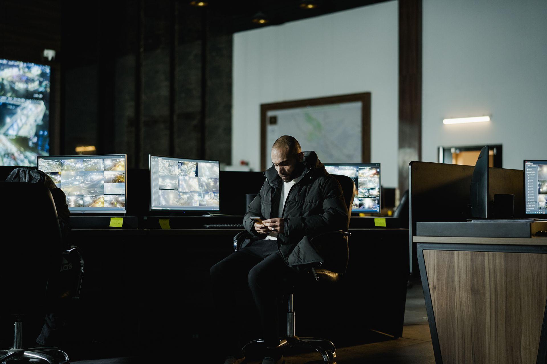 An operations control room lit by monitors